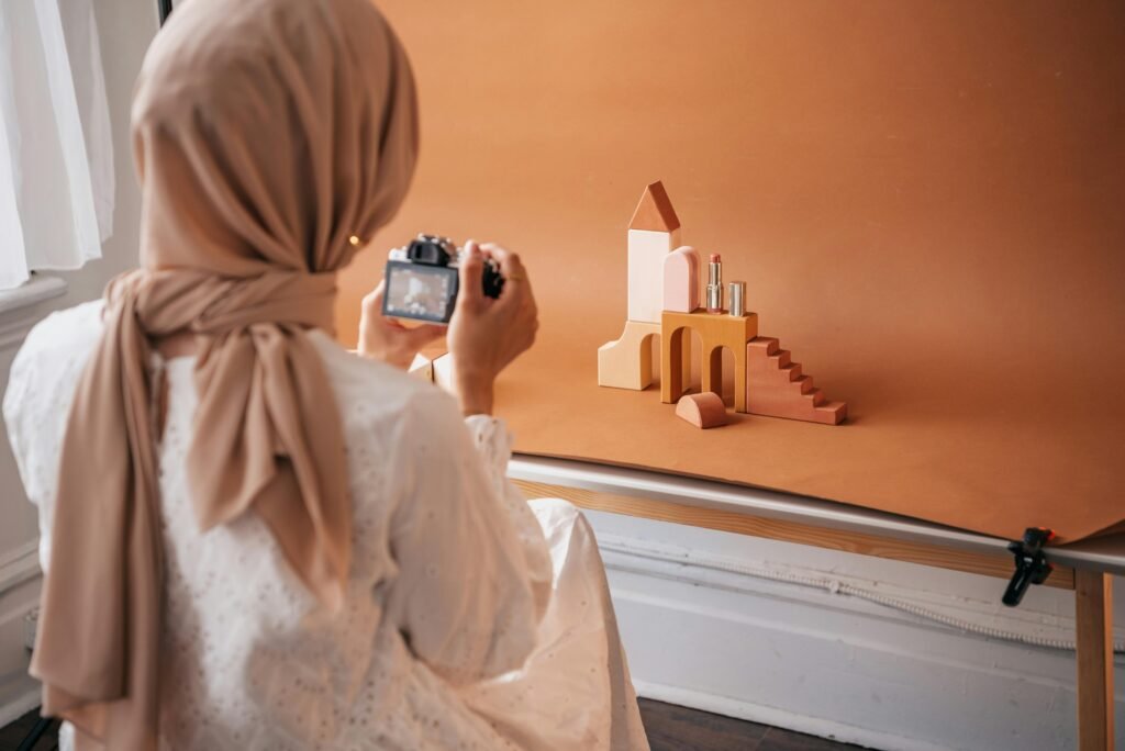 A Photographer Taking Photos of Wooden Blocks and a Lipstick